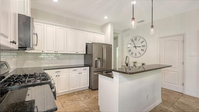 kitchen featuring a kitchen island, tasteful backsplash, white cabinetry, appliances with stainless steel finishes, and hanging light fixtures