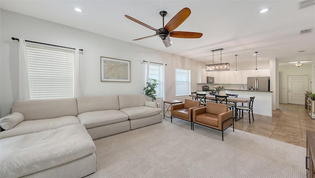 living room with recessed lighting, visible vents, and a ceiling fan