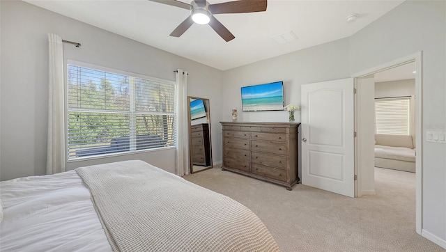 bedroom featuring light carpet, baseboards, and a ceiling fan