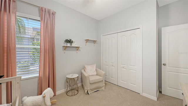 living area with light carpet, plenty of natural light, and baseboards