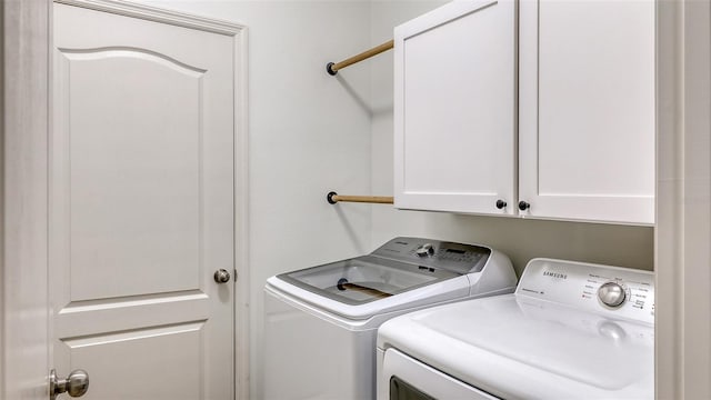 laundry room featuring cabinet space and separate washer and dryer