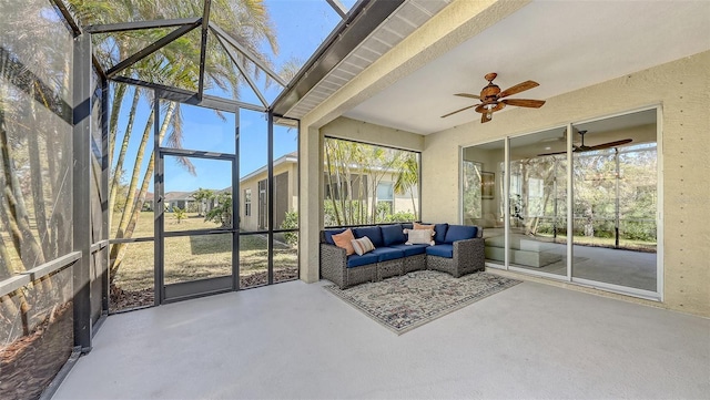 sunroom featuring a ceiling fan