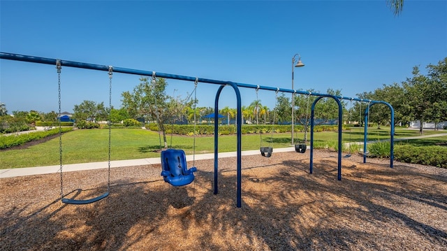 community jungle gym featuring a yard