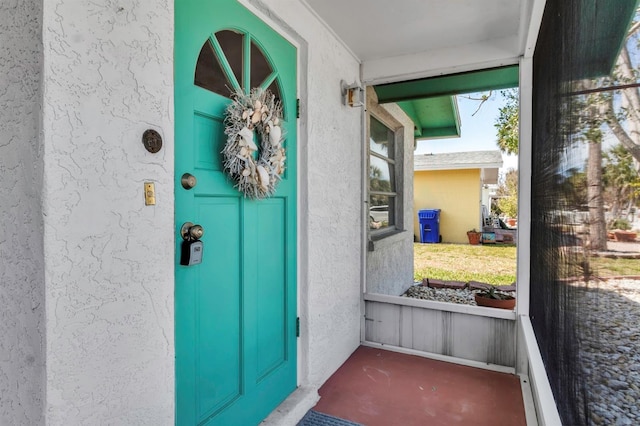 property entrance with stucco siding