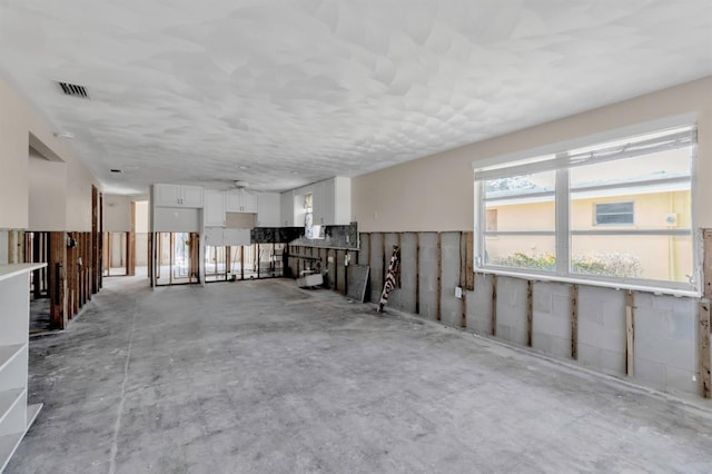 miscellaneous room featuring visible vents and concrete floors