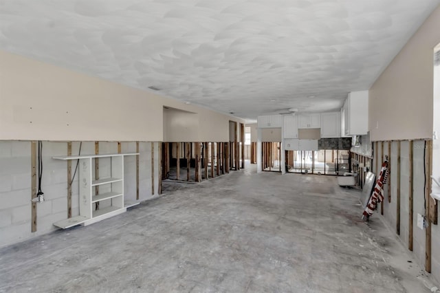 misc room with unfinished concrete flooring and visible vents