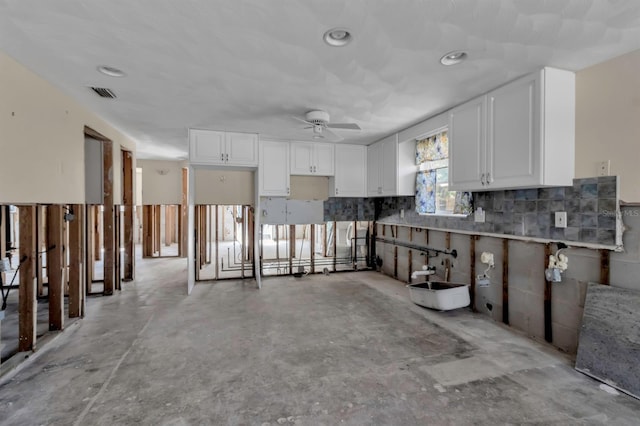 interior space with a ceiling fan and visible vents