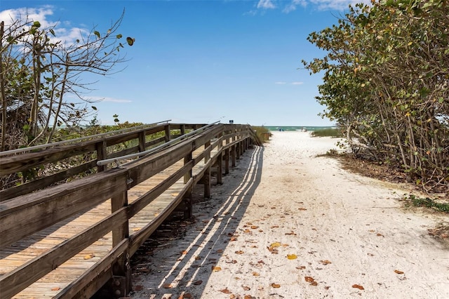 view of property's community with a view of the beach and a water view