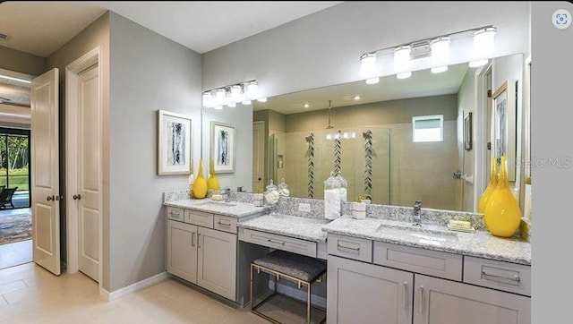 full bathroom with a shower stall, vanity, and baseboards