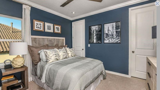 bedroom featuring a ceiling fan, baseboards, ornamental molding, a textured ceiling, and light carpet