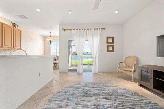 sitting room featuring recessed lighting, baseboards, light tile patterned flooring, and wallpapered walls