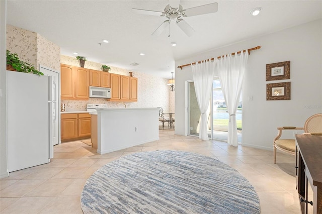 kitchen featuring a ceiling fan, wallpapered walls, white appliances, light countertops, and light tile patterned floors