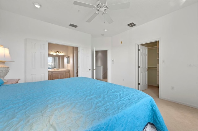 unfurnished bedroom featuring visible vents, carpet, ceiling fan, and ensuite bathroom