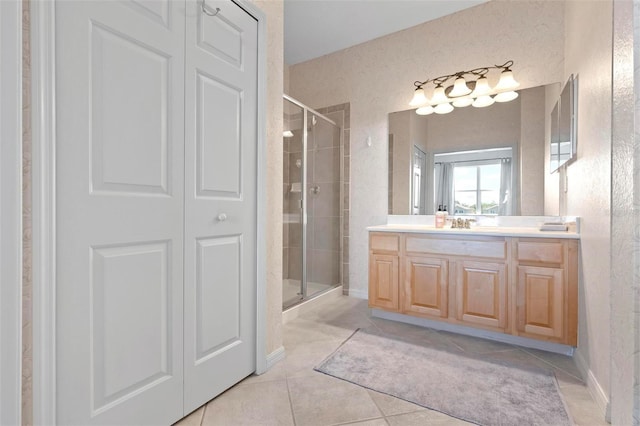 full bathroom with tile patterned floors, a closet, vanity, and a shower stall