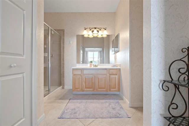 bathroom with tile patterned flooring, a shower stall, vanity, and baseboards