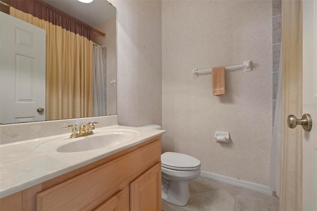 bathroom with tile patterned floors, baseboards, toilet, and vanity