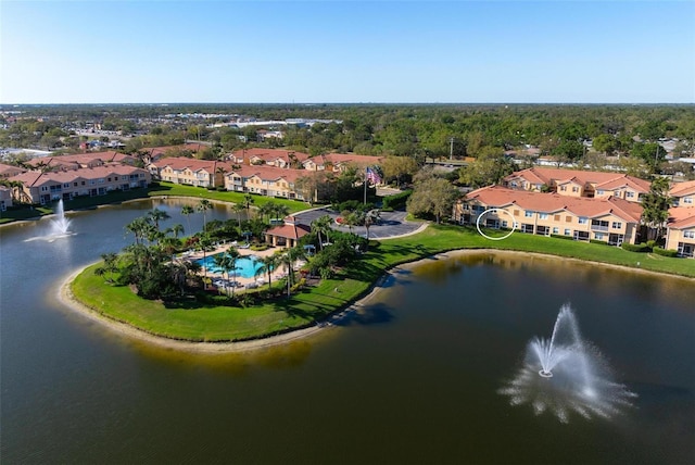 drone / aerial view with a water view and a residential view