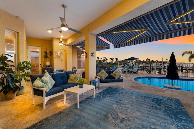 view of swimming pool with a fenced in pool, fence, a patio, ceiling fan, and an outdoor hangout area