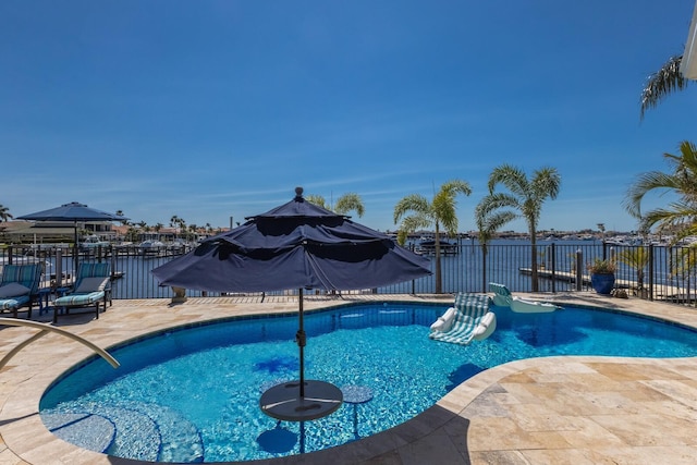 view of swimming pool with a patio area, a fenced in pool, and fence