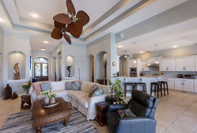 1009 3rd St E, Palmetto, FL 34221 - living area featuring ceiling fan, light tile patterned floors, arched walkways, a raised ceiling, and recessed lighting
