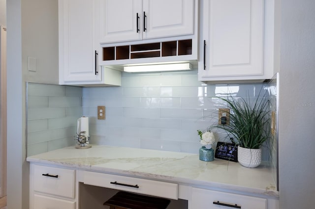 1009 3rd St E, Palmetto, FL 34221 - kitchen featuring white cabinetry, backsplash, light stone counters, and open shelves