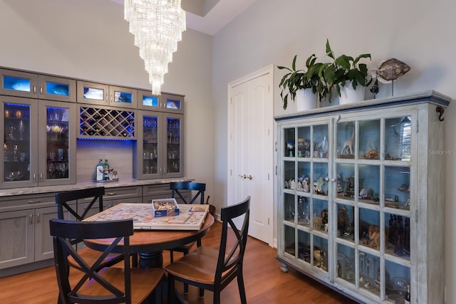 1009 3rd St E, Palmetto, FL 34221 - dining room with a chandelier, light wood-style flooring, and a high ceiling