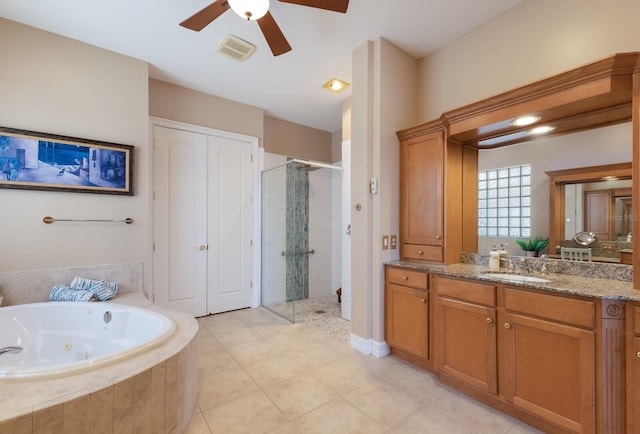1009 3rd St E, Palmetto, FL 34221 - bathroom with a shower stall, vanity, a tub with jets, a ceiling fan, and tile patterned flooring