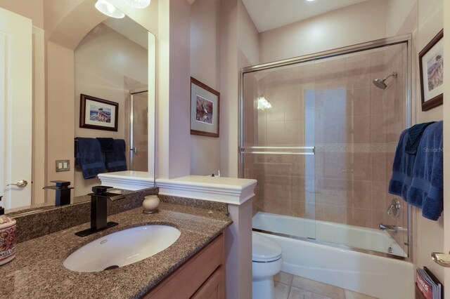 1009 3rd St E, Palmetto, FL 34221 - full bathroom featuring toilet, vanity, enclosed tub / shower combo, and tile patterned flooring
