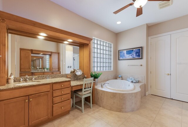1009 3rd St E, Palmetto, FL 34221 - bathroom featuring a bath, ceiling fan, vanity, and tile patterned flooring