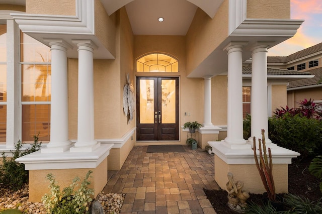 1009 3rd St E, Palmetto, FL 34221 - view of exterior entry with stucco siding and french doors