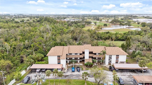 bird's eye view featuring golf course view and a water view