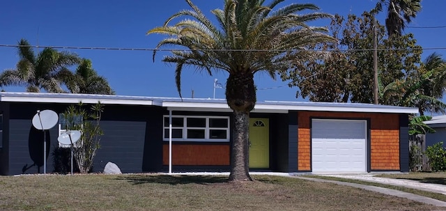 mid-century modern home featuring a garage