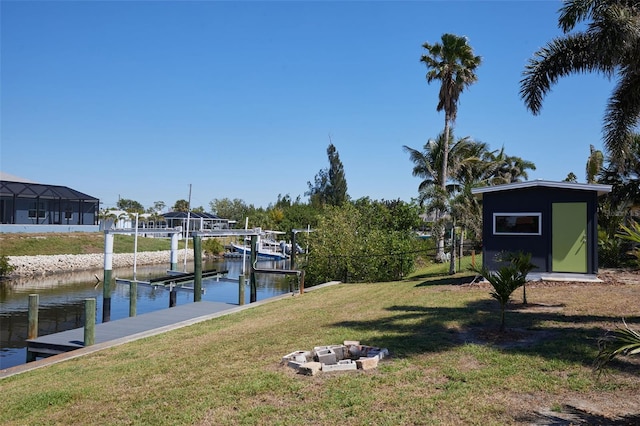 dock area featuring boat lift, a lawn, and a water view