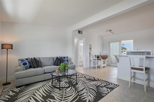 living area featuring light tile patterned flooring and visible vents