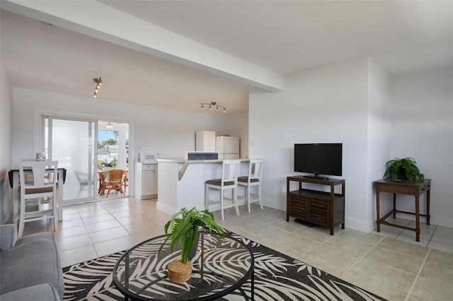 living room featuring baseboards and light tile patterned flooring