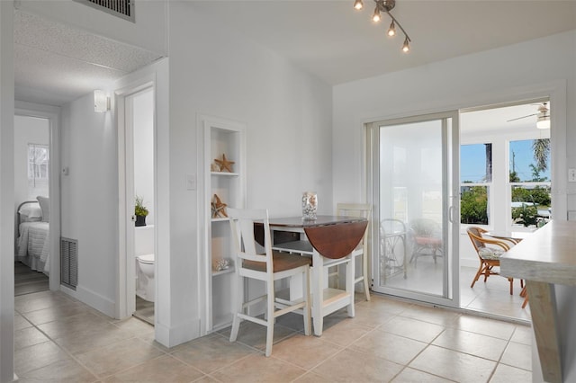 dining room with visible vents, baseboards, and tile patterned flooring