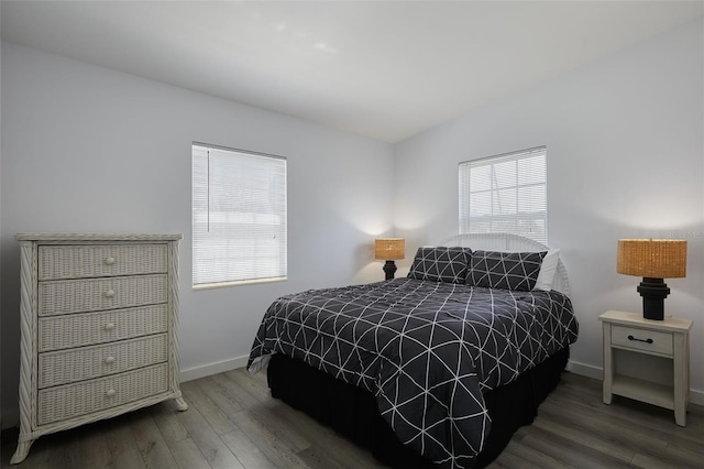 bedroom featuring baseboards and wood finished floors