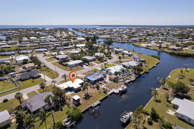 drone / aerial view featuring a residential view and a water view