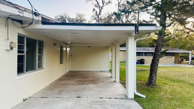 exterior space featuring an attached carport and driveway