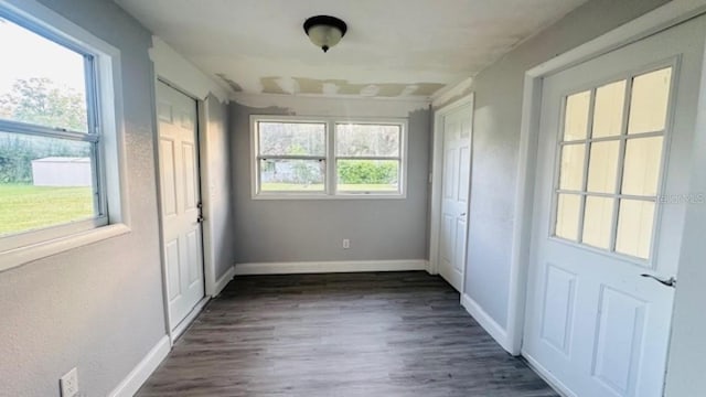 interior space featuring dark wood finished floors and baseboards