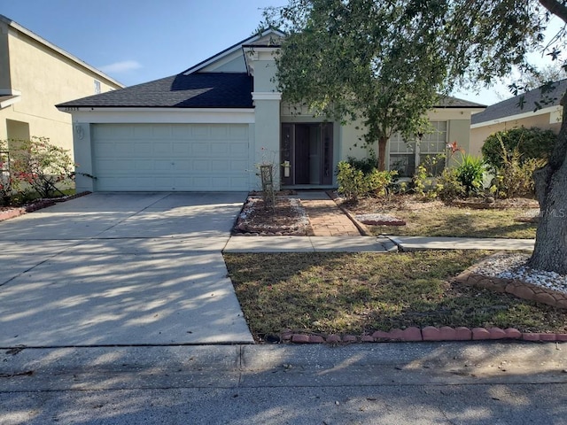 view of front of property with a garage, a shingled roof, driveway, and stucco siding