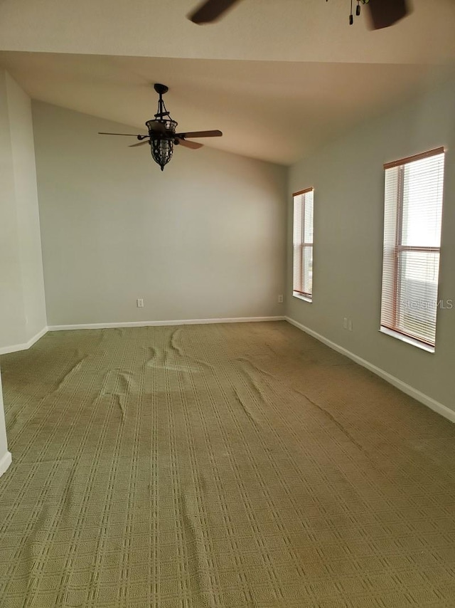 unfurnished room featuring a healthy amount of sunlight, baseboards, and ceiling fan