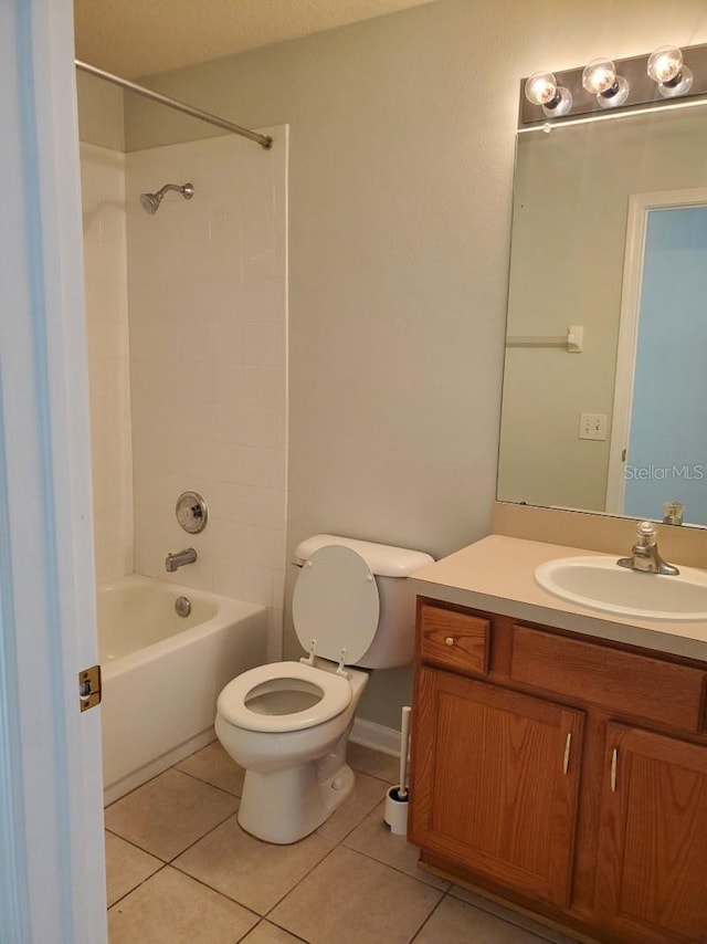 bathroom featuring tile patterned floors, toilet, vanity, and shower / bath combination