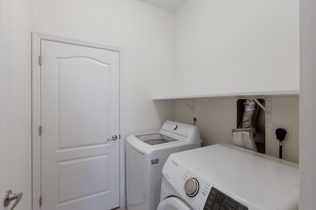 clothes washing area featuring laundry area and washing machine and clothes dryer