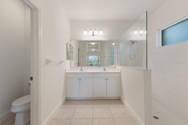 bathroom featuring tile patterned flooring, a walk in shower, toilet, and double vanity