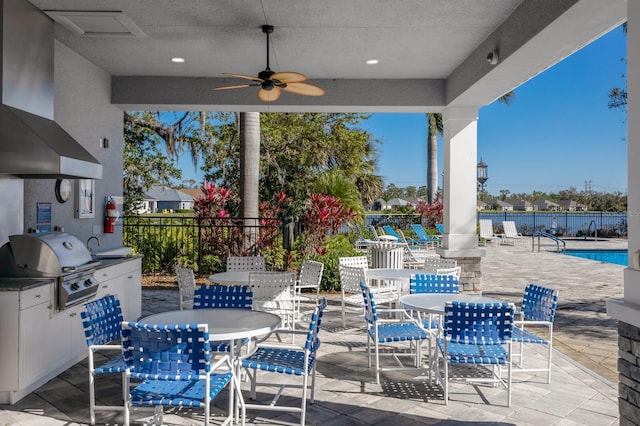 view of patio with outdoor dining area, a grill, a ceiling fan, and fence