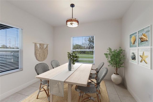 dining area with light tile patterned flooring and baseboards