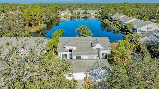 bird's eye view featuring a view of trees and a water view