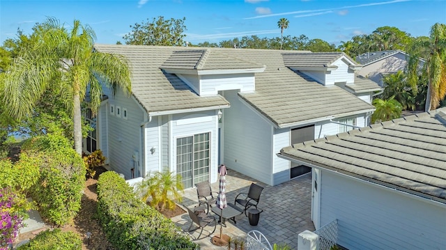 exterior space featuring a tiled roof and a patio area