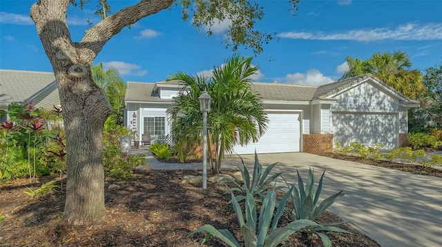 view of front of house with an attached garage, brick siding, and driveway